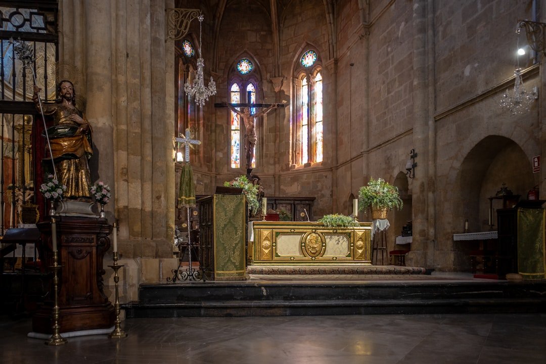 a church with a golden alter and stained glass windows