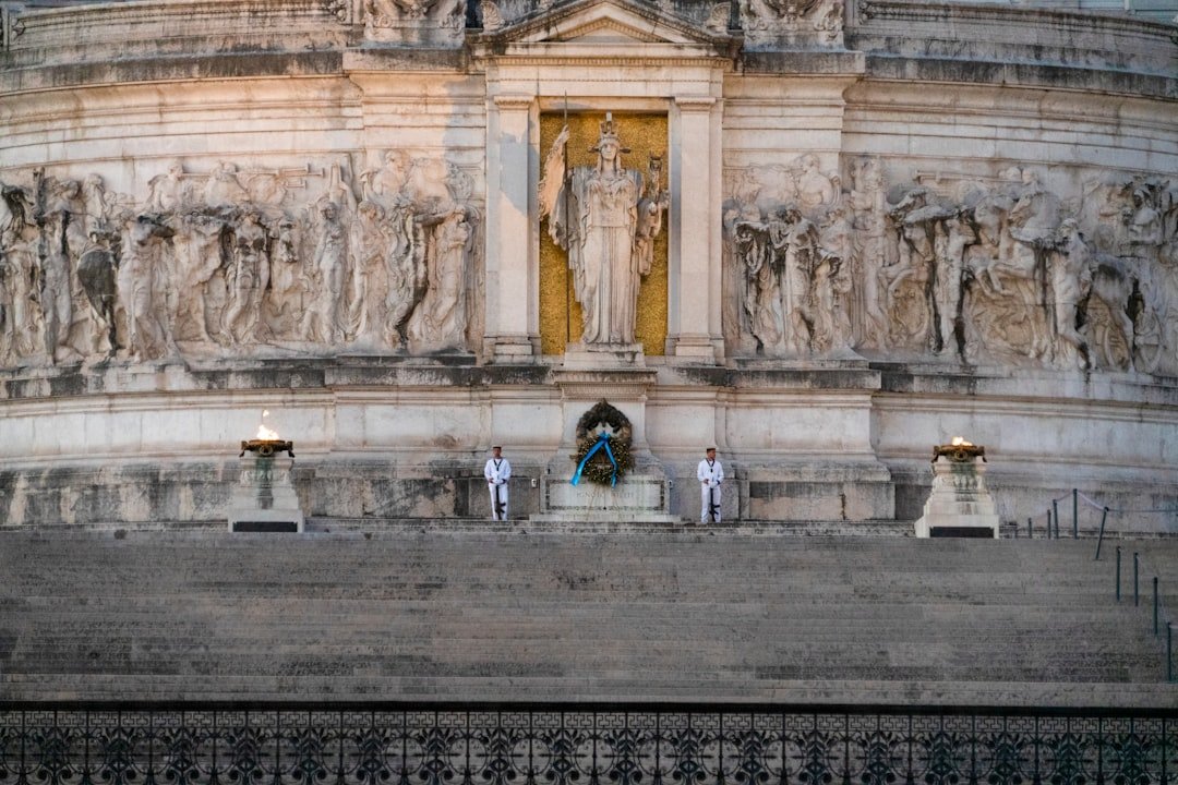 a group of people standing in front of a large stone building