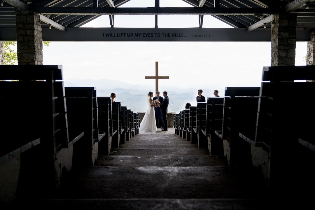 a bride and groom walking down the aisle of a church