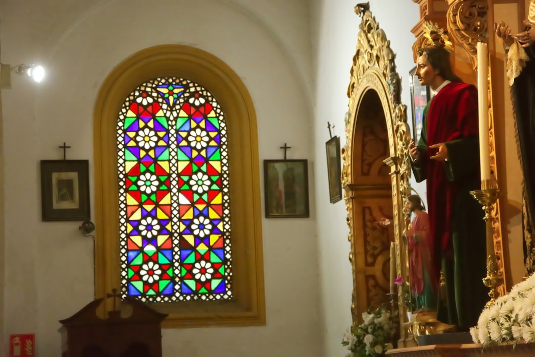 a person standing in front of a stained glass window