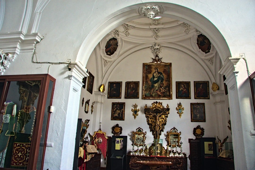 a church with a wall of pictures and paintings on the wall
