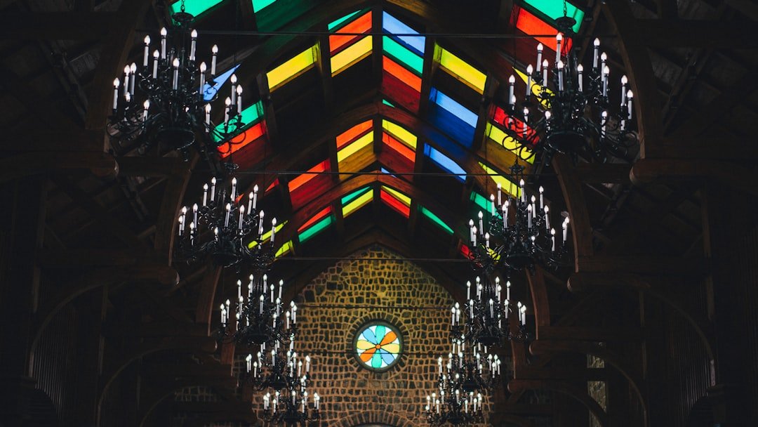 a church with a stained glass ceiling and chandelier