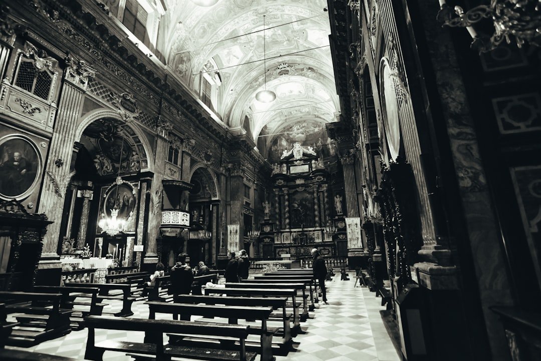 a black and white photo of a church with pews