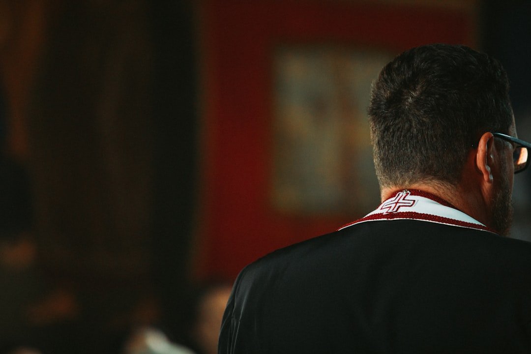 a man in a suit and tie with a cell phone to his ear