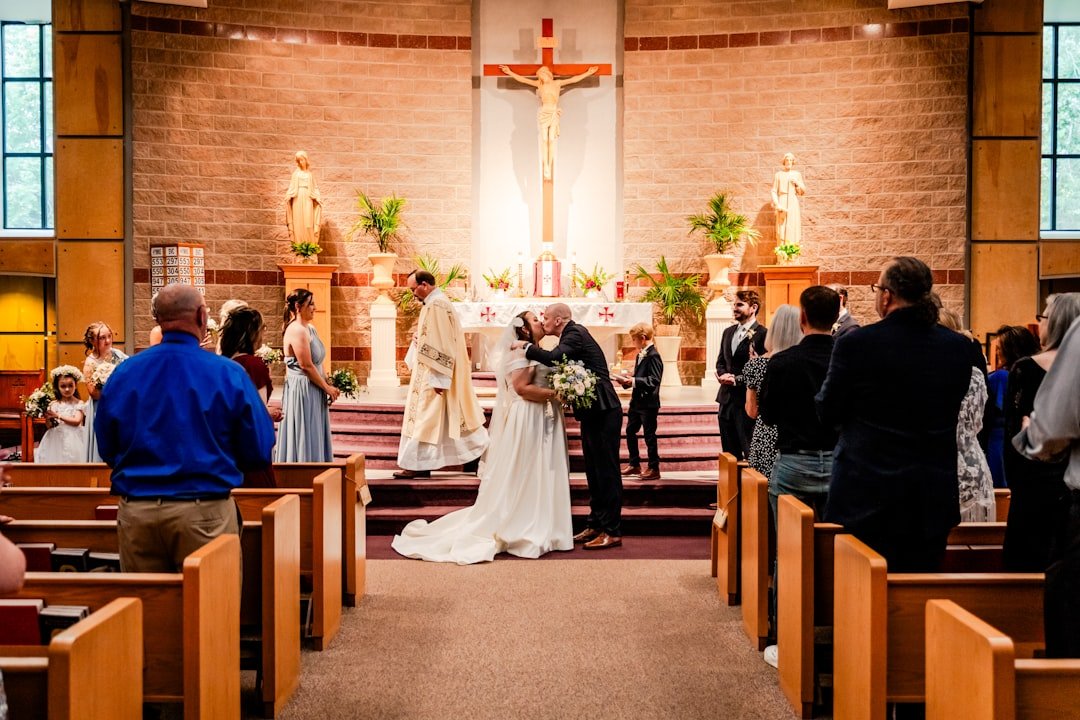 a bride and groom standing at the alter of a church