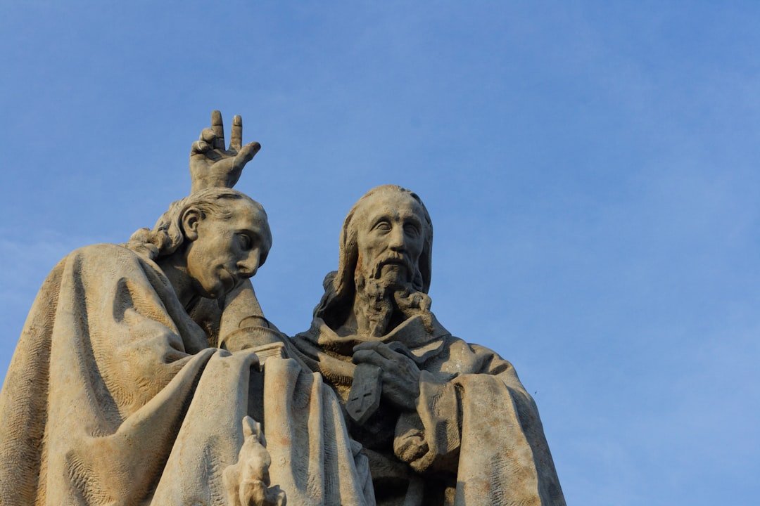 a statue of a man and a woman with their hands in the air