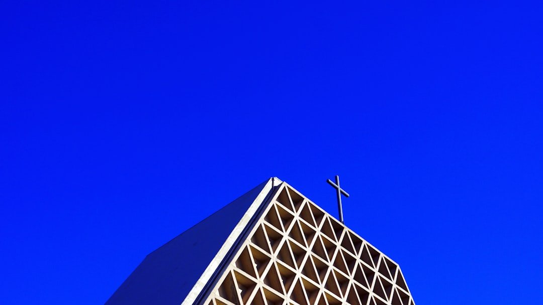 a tall building with a cross on top of it