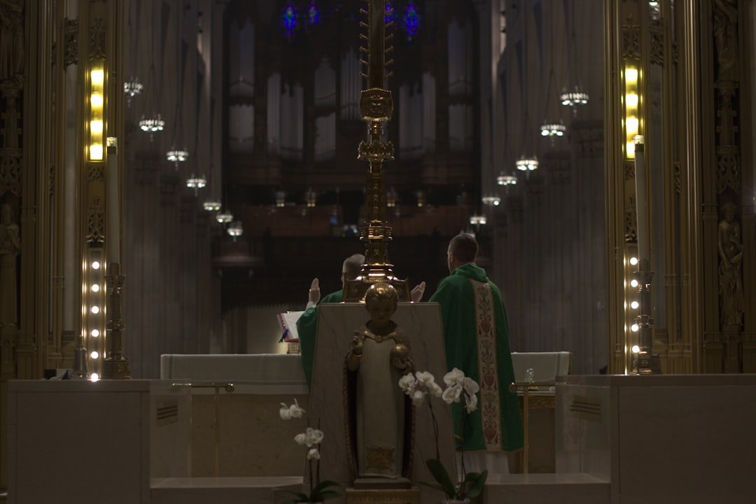 A priest is sitting in a large church