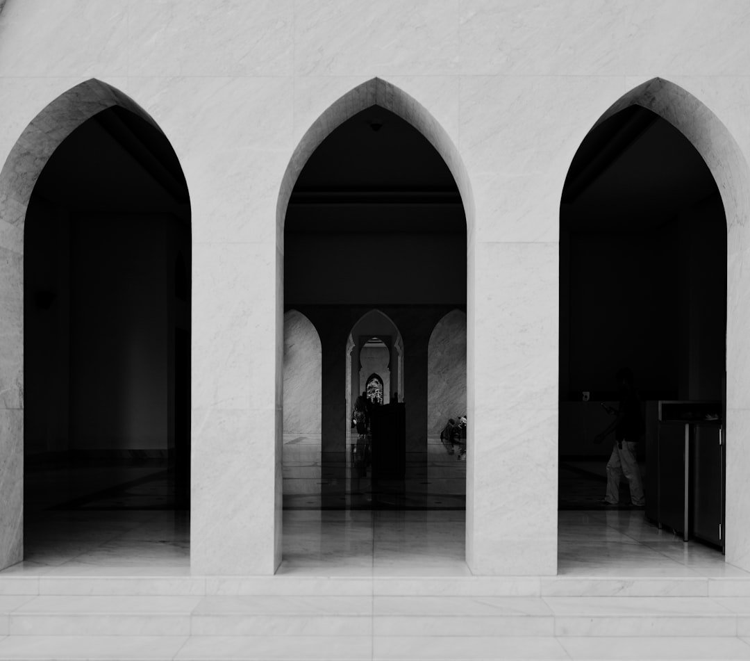 A black and white photo of a building with arches