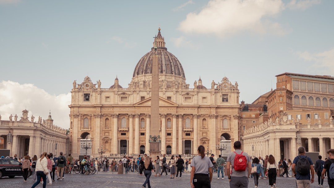 A group of people walking in front of a large building