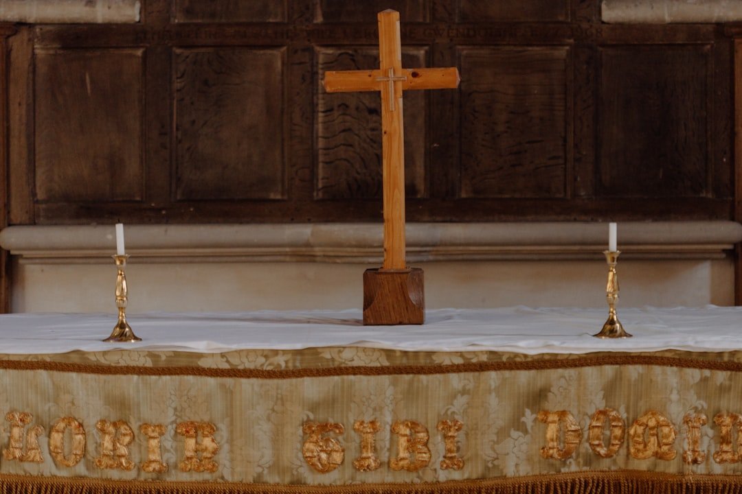 A cross on a table in front of a church