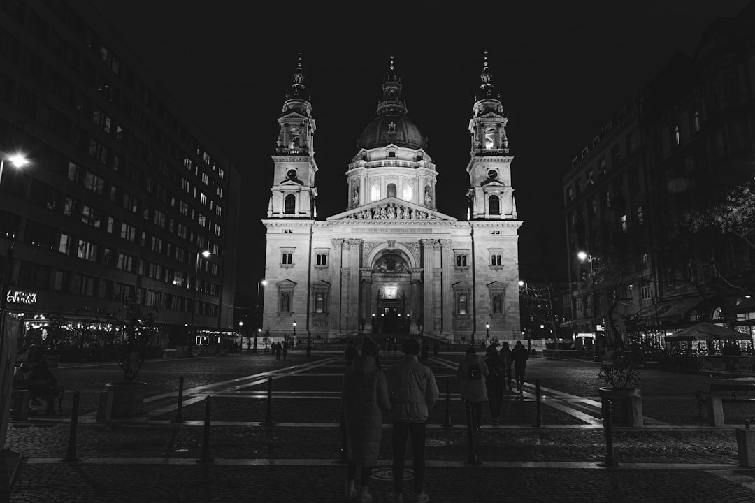 A black and white photo of a church at night