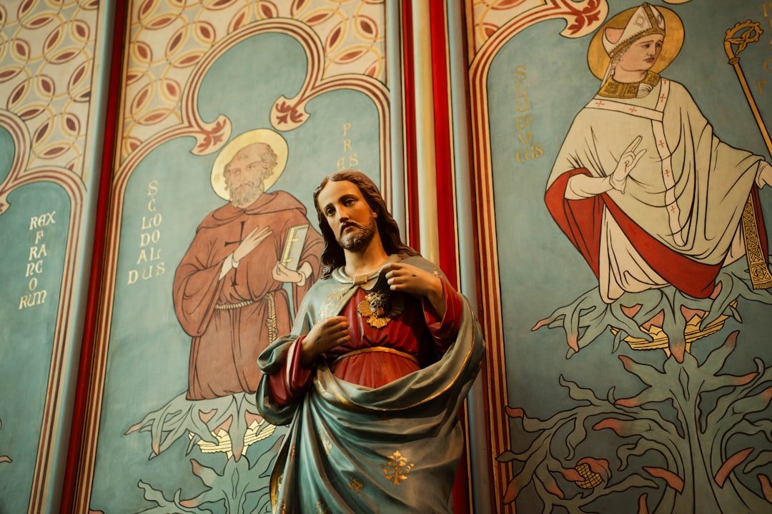 Statue of jesus with sacred heart and religious paintings