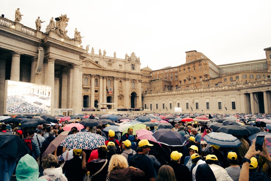 Crowd with umbrellas at st. peter's square, vatican city.