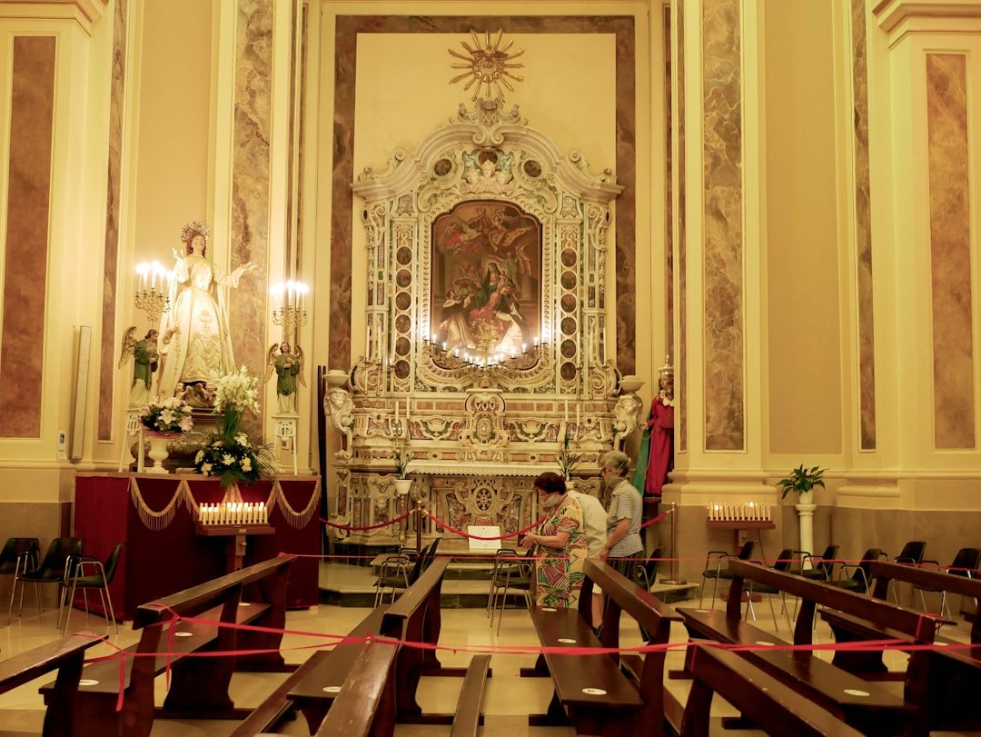 Interior of a church with ornate altar and pews.