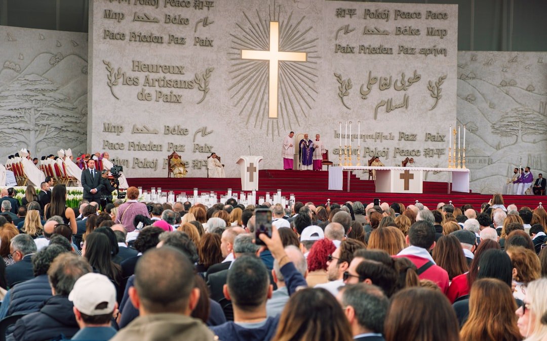Religious ceremony with a large crowd and cross